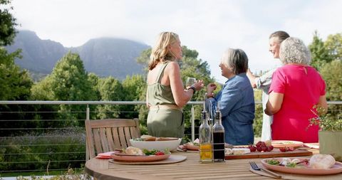 Senior Friends Enjoying Outdoor Gathering with Scenic Mountain View