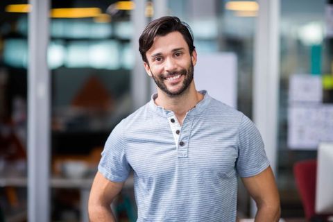 Smiling Young Professional in Modern Office