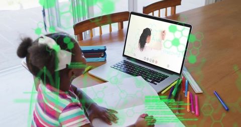 Child studying at home with laptop and markers, augmented reality remote learning