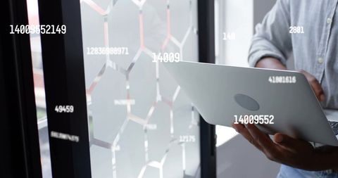 Businessman Using Laptop for Data Analysis in Modern Office