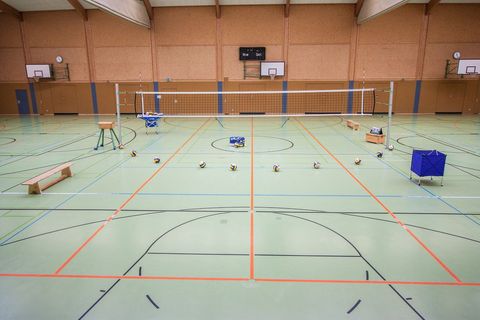 Empty School Gymnasium with Volleyball Setup