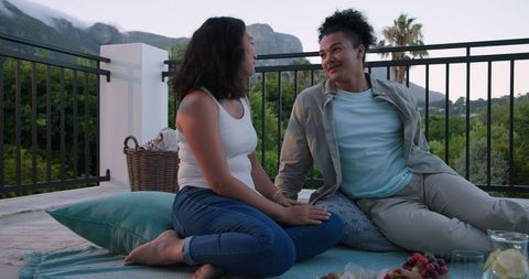 Friends Enjoying Outdoor Picnic on Scenic Mountain Patio