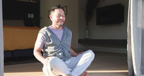 Senior Asian Man Practicing Mindfulness in Home Bedroom