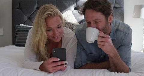 Relaxed Couple Enjoys Leisure Time in Cozy Hotel Room - Download Free Stock Images Pikwizard.com