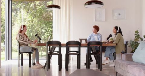 Diverse team recording podcast in modern home setting