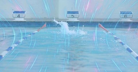 Water splash at competitive swimming pool creating ripples