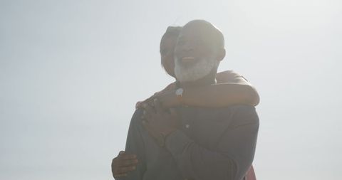 Joyful Senior Couple Enjoying Sunny Beach Day