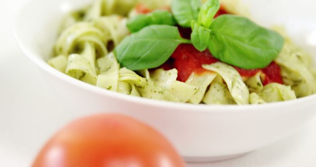 Close-Up of Fresh Pesto Pasta with Basil and Tomato Sauce Garnish - Download Free Stock Images Pikwizard.com