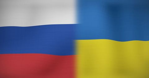 Inflation Text Overlaying Russian and Ukrainian Flags Symbolizing Economic Impact