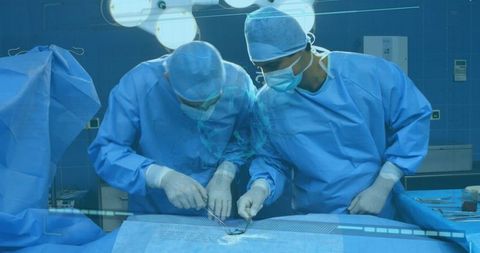 Diverse Surgeons Perform Surgery with COVID-19 Graphic Overlay - Download Free Stock Images Pikwizard.com