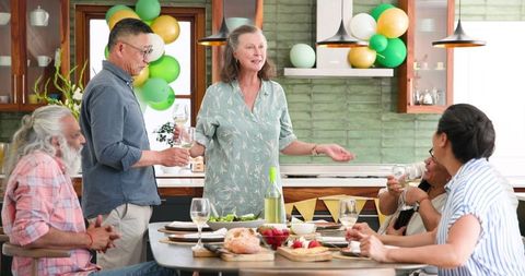 Seniors Enjoying Dynamic Dinner Party Toast with Friends