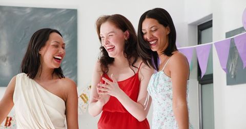 Joyful friends celebrating birthday with confetti and laughter