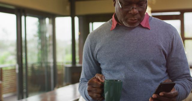 Senior Man Drinking Coffee and Using Smartphone at Home - Download Free Stock Images Pikwizard.com