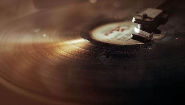Spinning vinyl record on turntable creating melodious sound