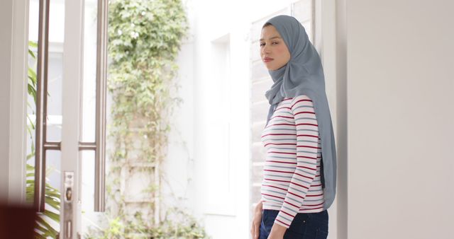 Young Muslim Woman in Striped Shirt Posing Indoors Natural Light - Download Free Stock Images Pikwizard.com