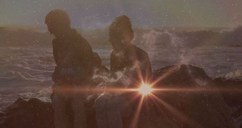 Silhouetted Couple Enjoying Romantic Twlight by Ocean