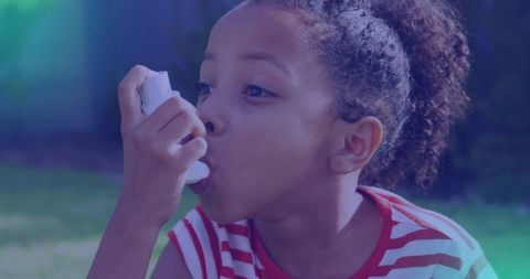 Young Girl Using Inhaler Outdoors in Striped Shirt - Download Free Stock Images Pikwizard.com