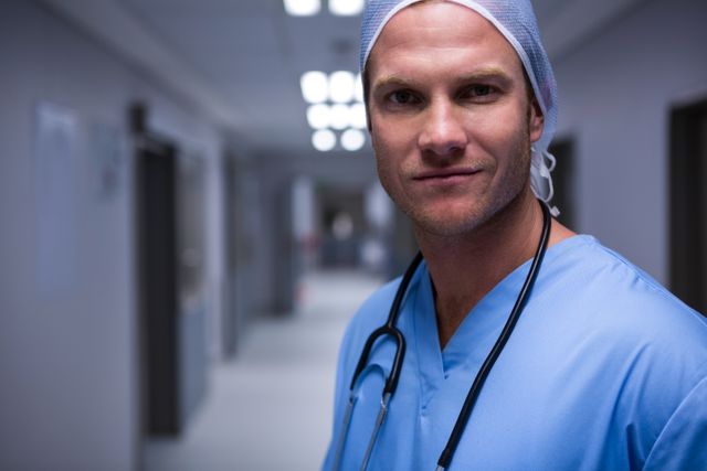 Portrait of surgeon standing in corridor at hospital
