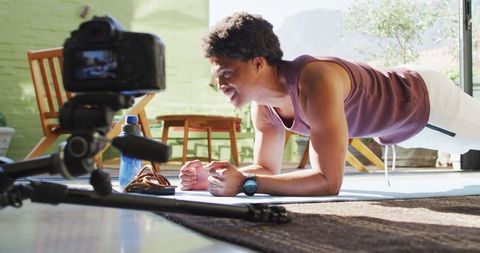 African American Man Filming Fitness Vlog Doing Plank Exercise