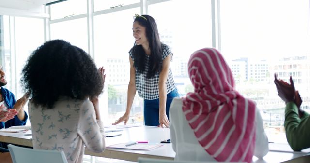 Confident Young Woman Presenting to Diverse Team in Modern Office - Download Free Stock Images Pikwizard.com