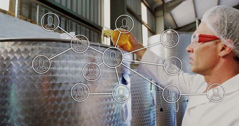 Technician Inspecting Liquid Sample in Modern Brewery Setting