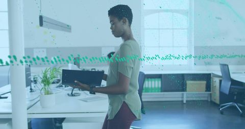 Businesswoman Analyzing Data on Digital Tablet in Modern Workspace