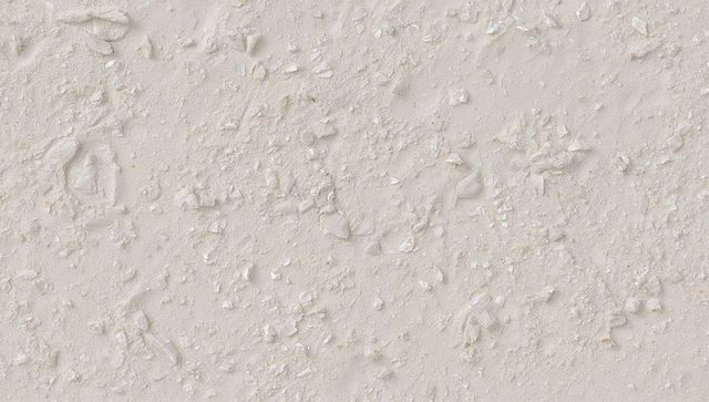 Beige plaster texture showing peeling stucco, cracked flakes and gritty rough surface