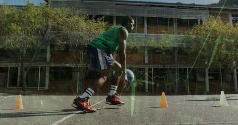 Urban athlete dribbling basketball through cone drill on asphalt court with red shoes