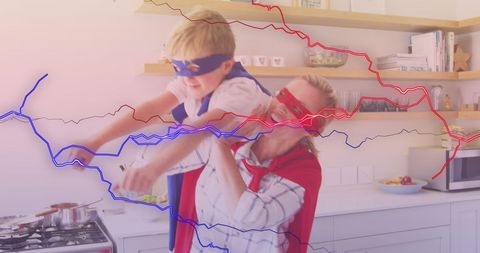 Mother and Son Playing Superheroes in Kitchen