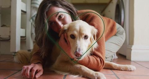Woman hugging cream-colored dog on cozy tile floor at home