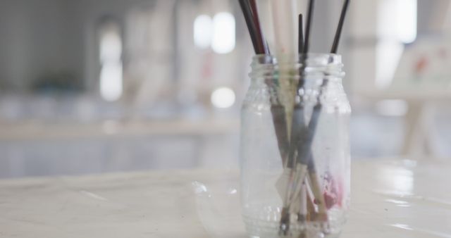 Artistic Paintbrushes Standing in Glass Jar on Table - Download Free Stock Images Pikwizard.com