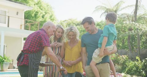Family Gathering in Garden with Outdoor Barbecue