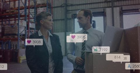 Business professionals discussing logistics in industrial warehouse