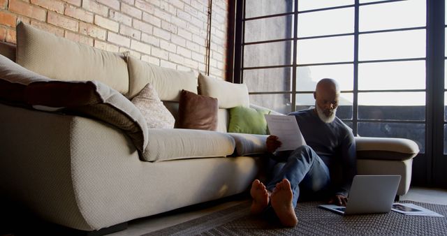 Mature Man Working from Home Sitting on the Floor - Download Free Stock Images Pikwizard.com