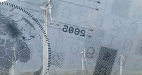 Wind turbines spinning with data overlay emphasizing renewable energy transition