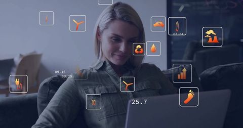 Woman Smiling at Laptop Surrounded by Floating Eco-Friendly Icons