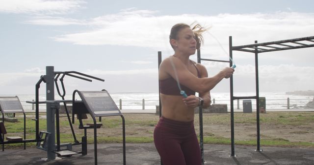 Fit Woman Jump Roping in Outdoor Gym by the Beach - Download Free Stock Images Pikwizard.com