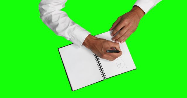 Man drawing on blank notebook with green screen background - Download Free Stock Images Pikwizard.com