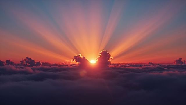 Majestic Sunrise with Radiant Sunbeams Above Cloud Layer