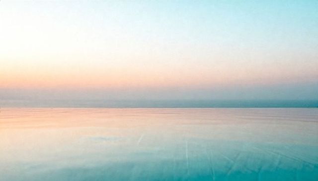 Pastel sea horizon reflecting glassy turquoise water calm sunrise minimalist background