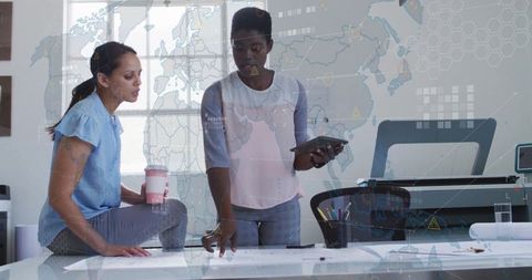 Architects Collaborating on Blueprints in Modern Workspace