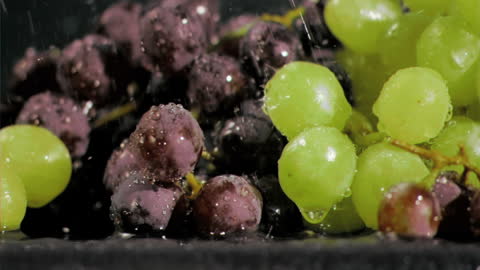 Vibrant Grapes Showered with Water in Slow Motion
