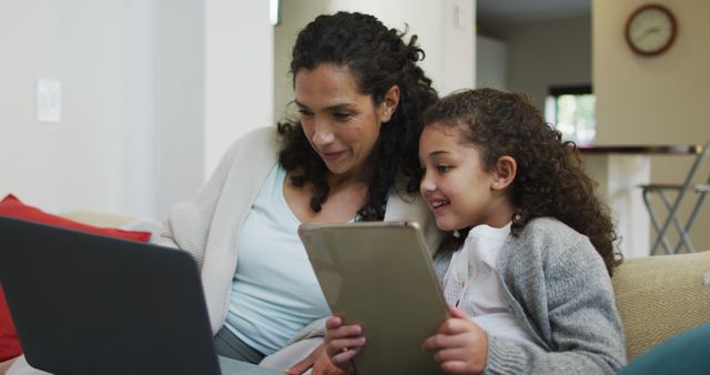 Mother and Daughter Using Digital Devices on Couch - Download Free Stock Images Pikwizard.com