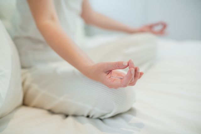Woman Meditating on Bed in Bedroom - Download Free Stock Photos Pikwizard.com