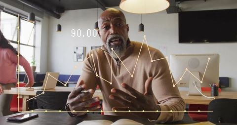 Professional analyst presenting graph trends in modern coworking space