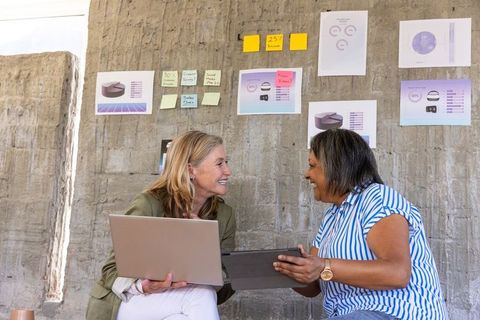 Diverse female colleagues engaging in productive brainstorming session