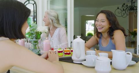 Diverse Friends Enjoying Lively Brunch Conversation Outdoors