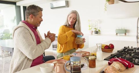 Senior Couple Enjoying Breakfast in Modern Kitchen Setting
