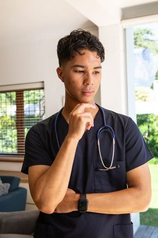 Thoughtful Asian Male Medical Professional Contemplating Future
