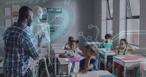 Black teacher demonstrating human skeleton with augmented reality in elementary classroom